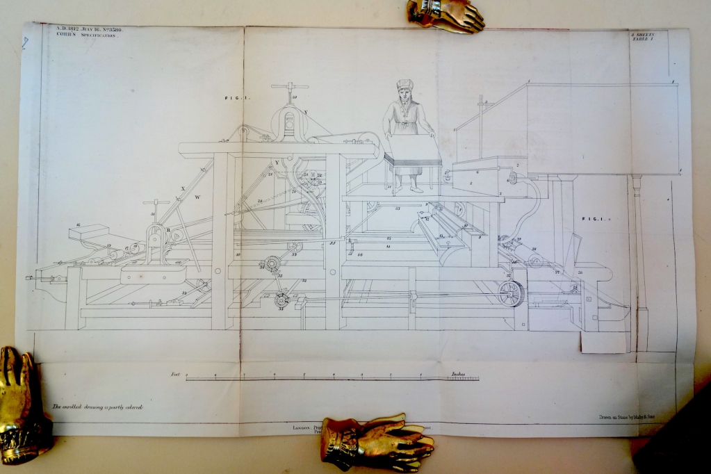 This photograph of the drawing of Cobb's machine for his patent has shows flap down on the right side of the machine.