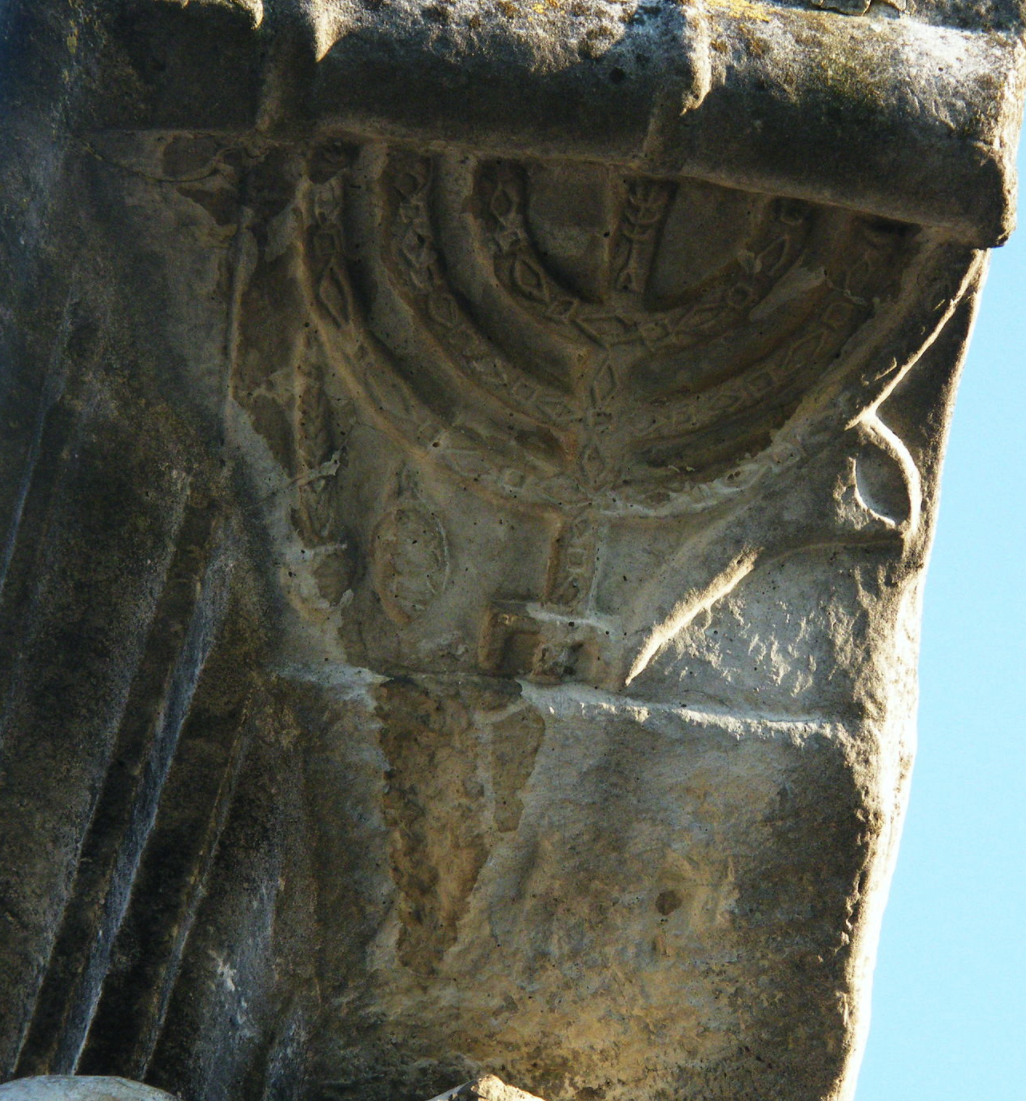 Detail of a menorah relief on a column in the Ostia synagogue.