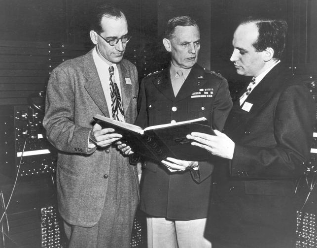 John W. Mauchly and J. Presber Eckert photographed probably in front of the ENIAC with an unidentified U.S. Army officer.