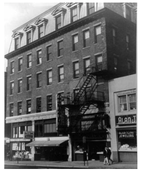 Building in which the New Haven District Telephone office and first telephone exchange were located in New Haven, Connecticut, in the store front with the awning.