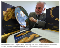 Scientist with replica of the Nebra Sky Disk