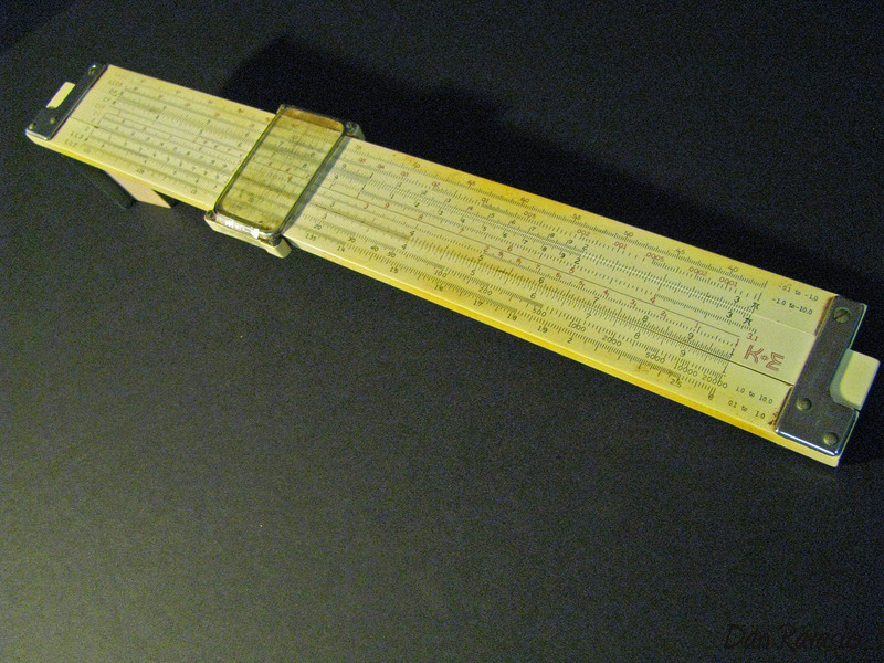 A modern photograph of a vintage sliding stick side rule.