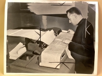 This press photo of Robert Busa comparing the text of the Dead Sea Scrolls with print-outs from the IBM 705 shows crop marks and white-outs from the publication process.