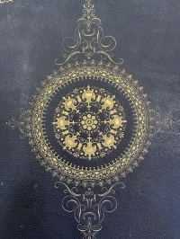 From this enlargement of the center ornament on the lower cover of the binding you can see the exquisite detail involved.
