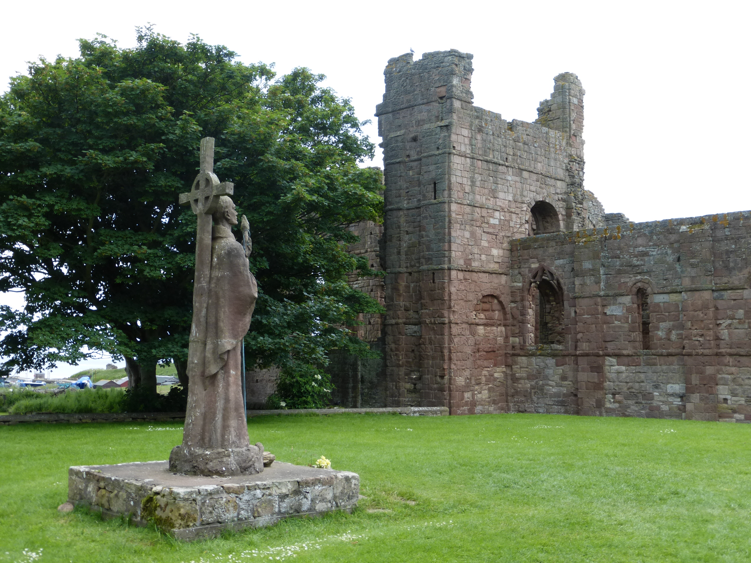 Lindisfarne Priory ruins and St. Aidan statue