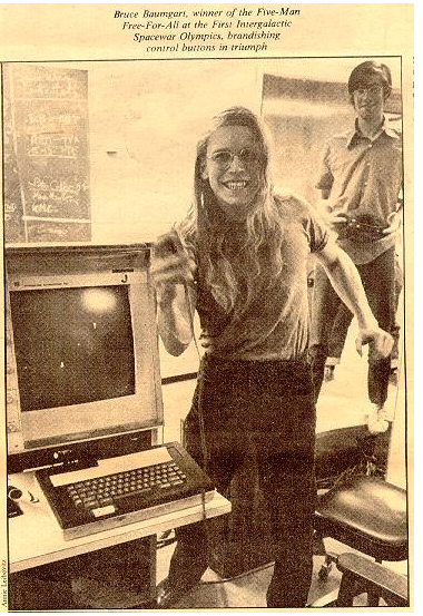photograph by Annie Leibowitz captioned, "Bruce Baumgart, winner of the Five-Man Free-For-All at the First Interfalactice Spacewar Olympics, brandishing control buttons in triumph."