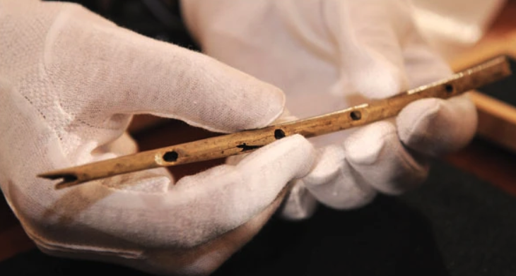 A thin bird-bone flute carved  35,000 years ago. Credit...Daniel Maurer/Associated Press