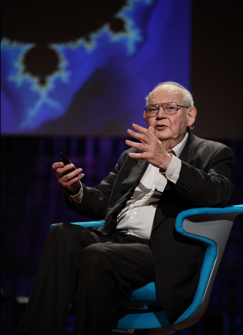 Benoit Mandelbrot talking at TED (Technology, Entertainment, Design) conference in 2010 with a fractal in the background.