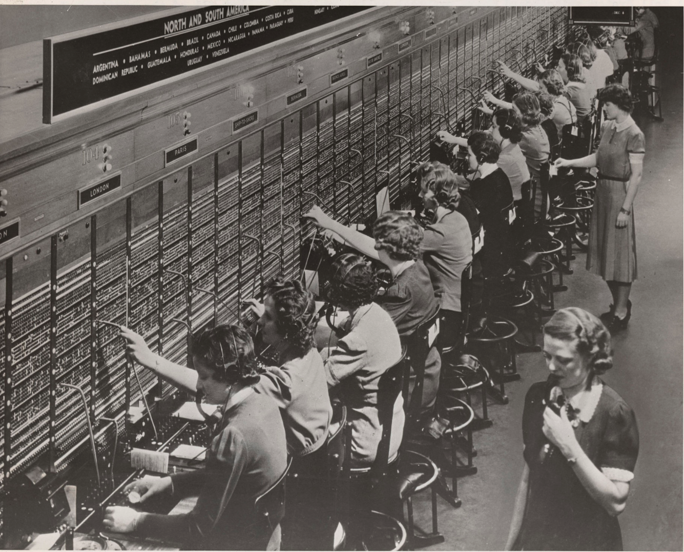 A manual international telephone switchboard and its operators in 1943.