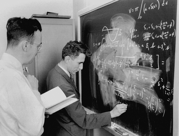 Claude Shannon writing on the blackboard at Bell Labs during World War II. Photo: Nokia Bell Labs.