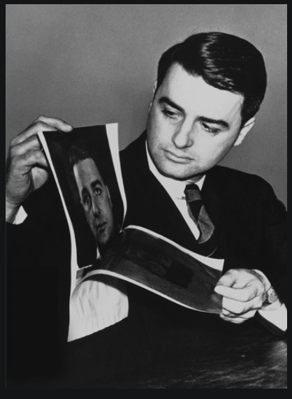Edwin Land demonstrating an instant Polaroid photograph of himself