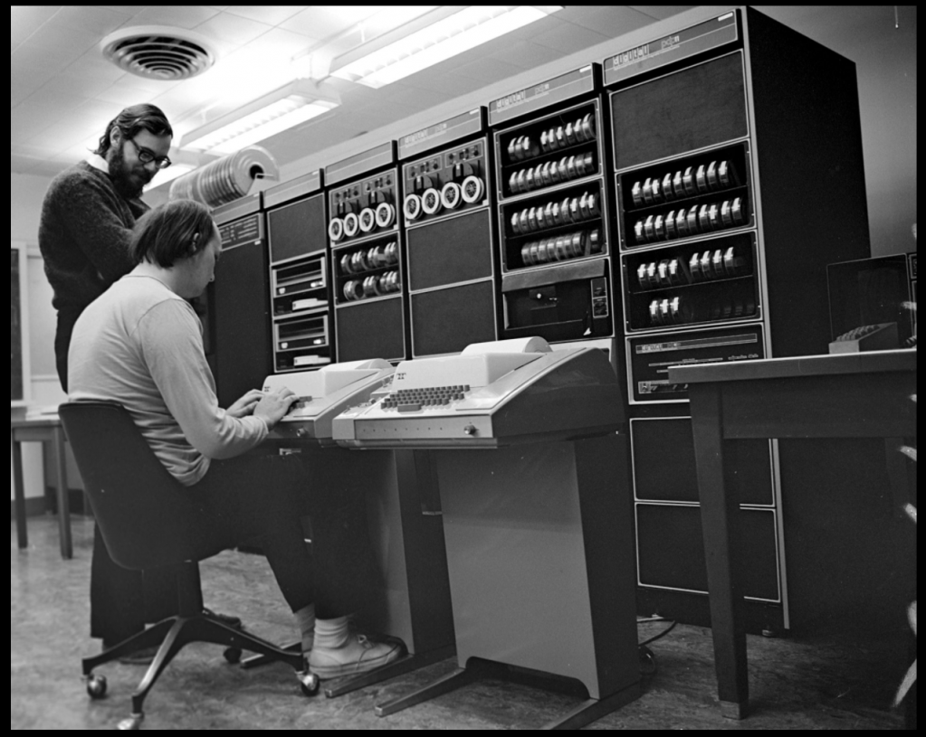 Ken Thompson (sitting) and Dennis Ritchie working together at a PDP-11