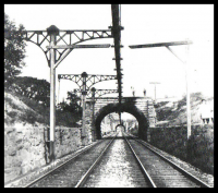 Original overhead third-rail system on the Baltimore Belt Line of the Baltimore and Ohio Railroad, part of the first mainline railroad electrification in 1895. Photo from 1901.
