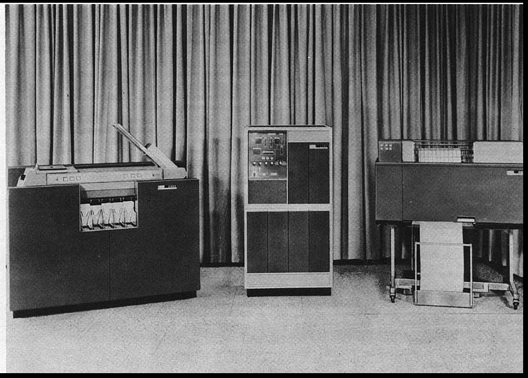 The IBM 1401 Data Processing System with the 1402 Card Read-Punch on the left, the 1401 Processing Unit in the middle and the 1403 Line Printer on the right.