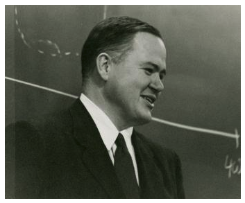 photograph of John W. Tukey in front of a blackboard