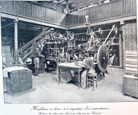 Workers using a machine for gilding and printing covers for books at the bindery for the Librairies-Imprimerie Reunie.
