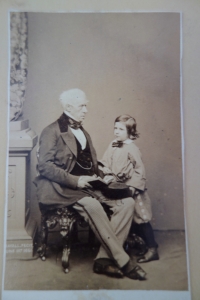 This photograph of Brougham, presumably with a grandson, is signed Bayall and dated June 1861 on the base of the column within the image.